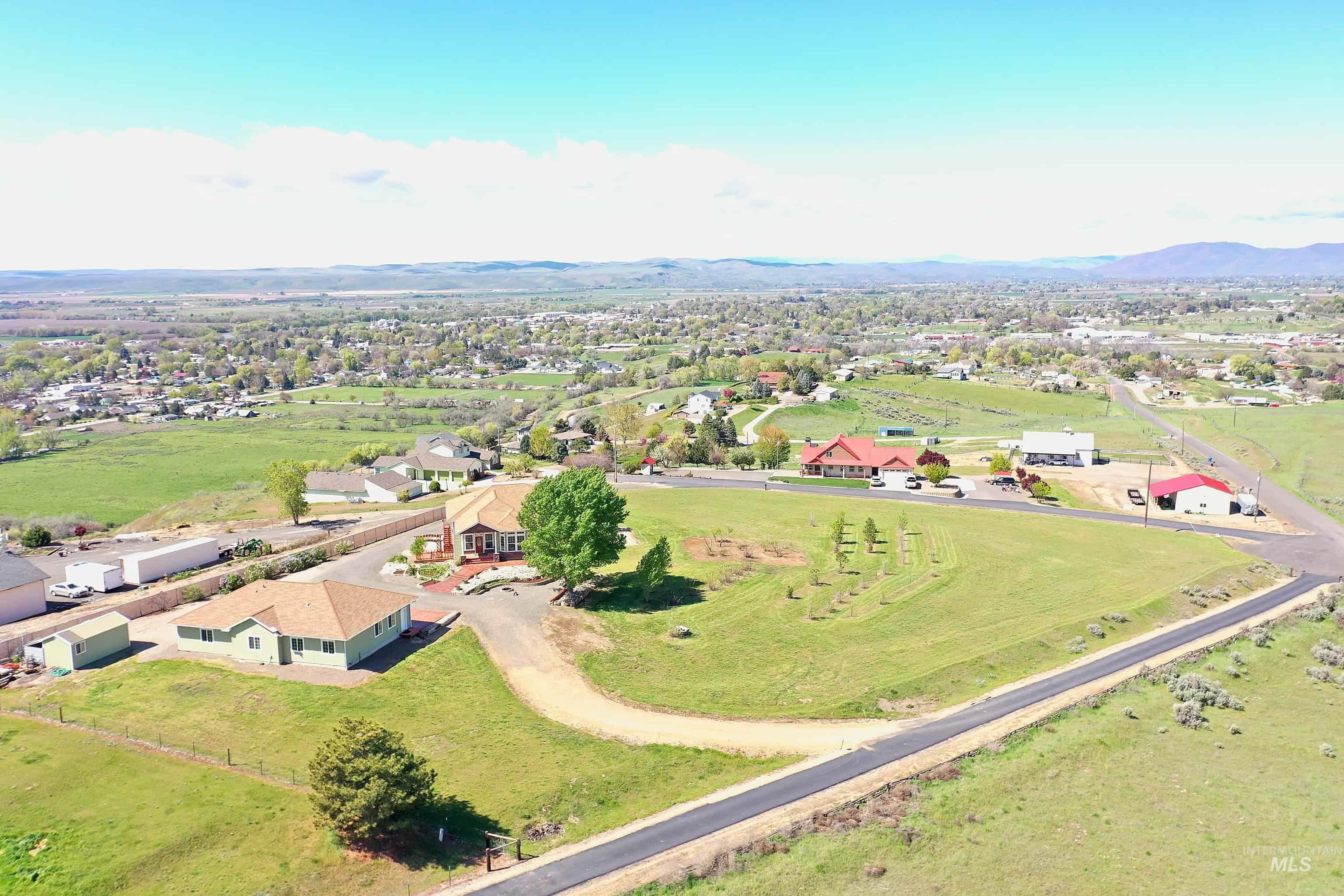 View of rural area featuring mountains and nearby suburban area