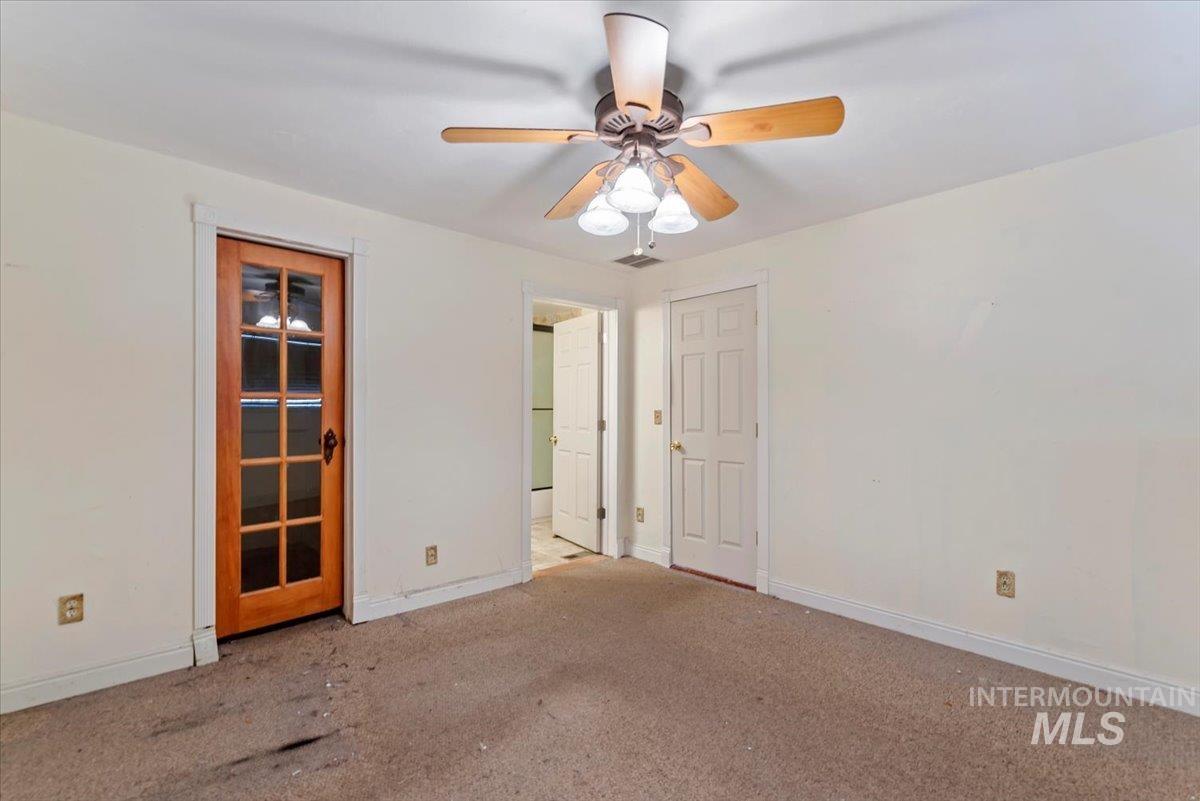 Unfurnished bedroom featuring carpet and ceiling fan