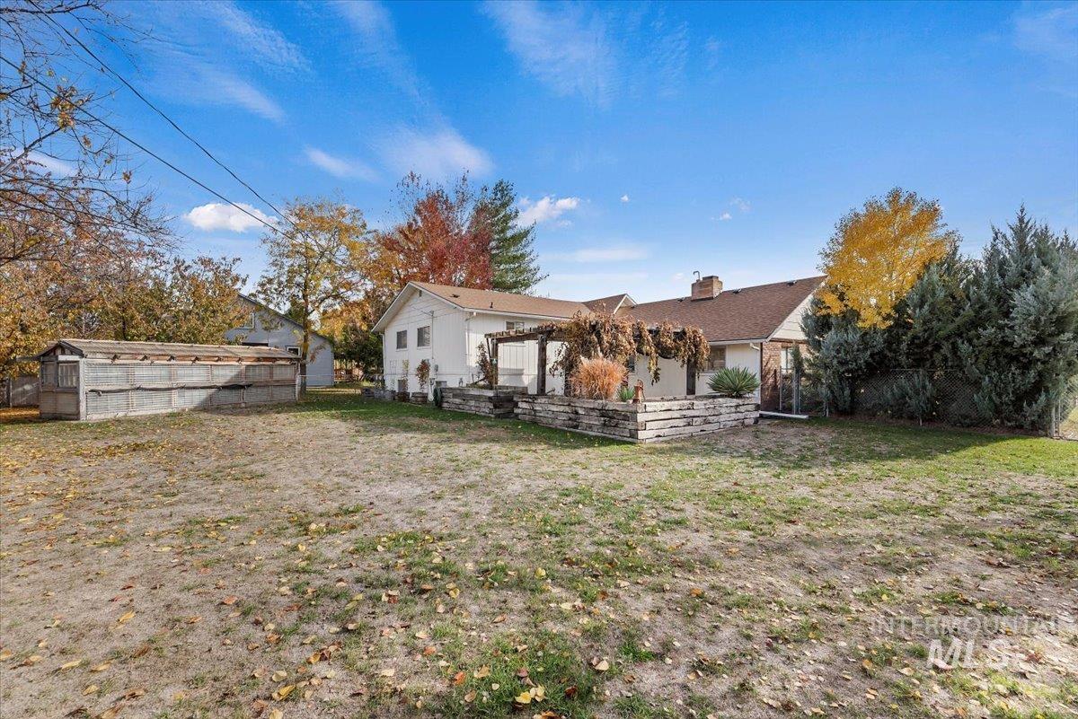 Rear view of property featuring a chimney