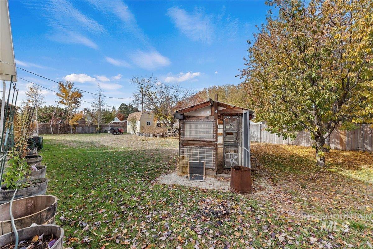 Fenced backyard featuring an outdoor structure and exterior structure