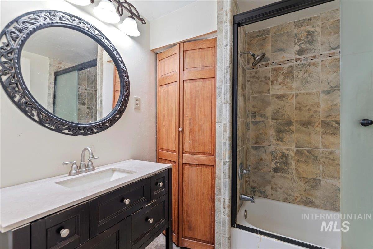 Full bath featuring vanity and tiled shower / bath combo