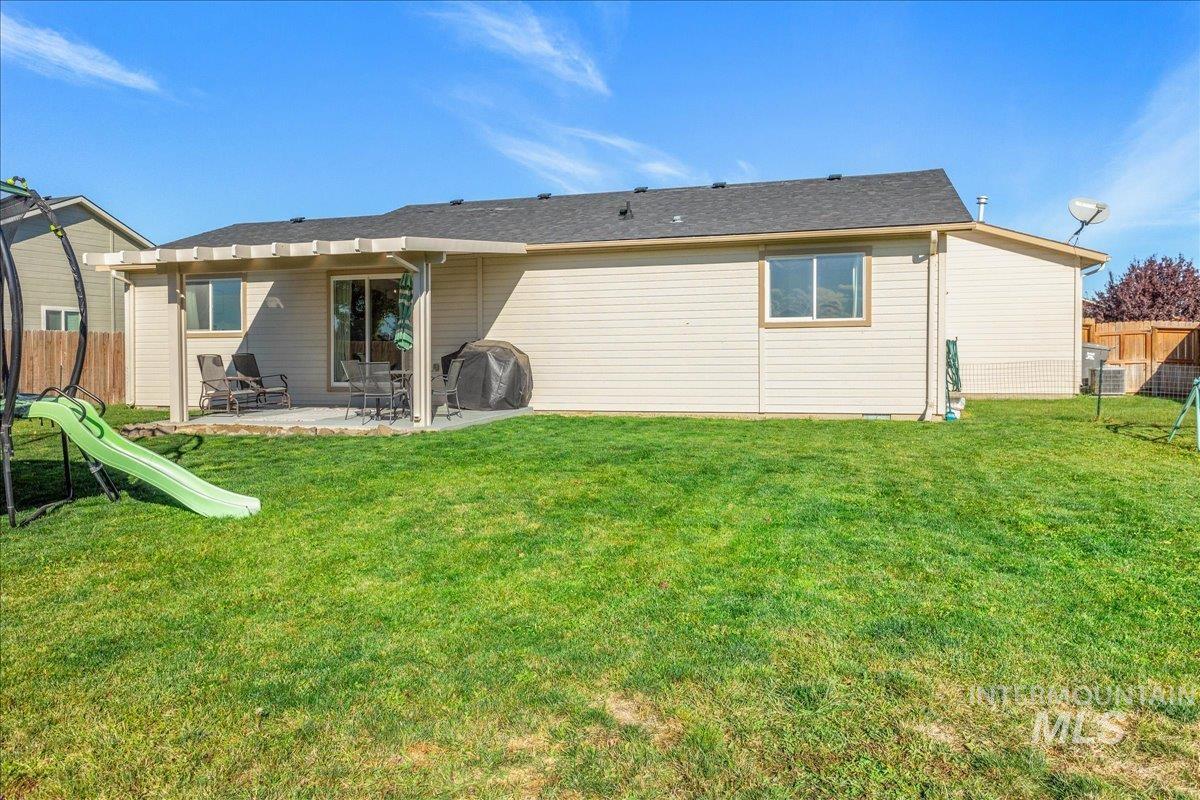 Back of property featuring a patio area and a playground