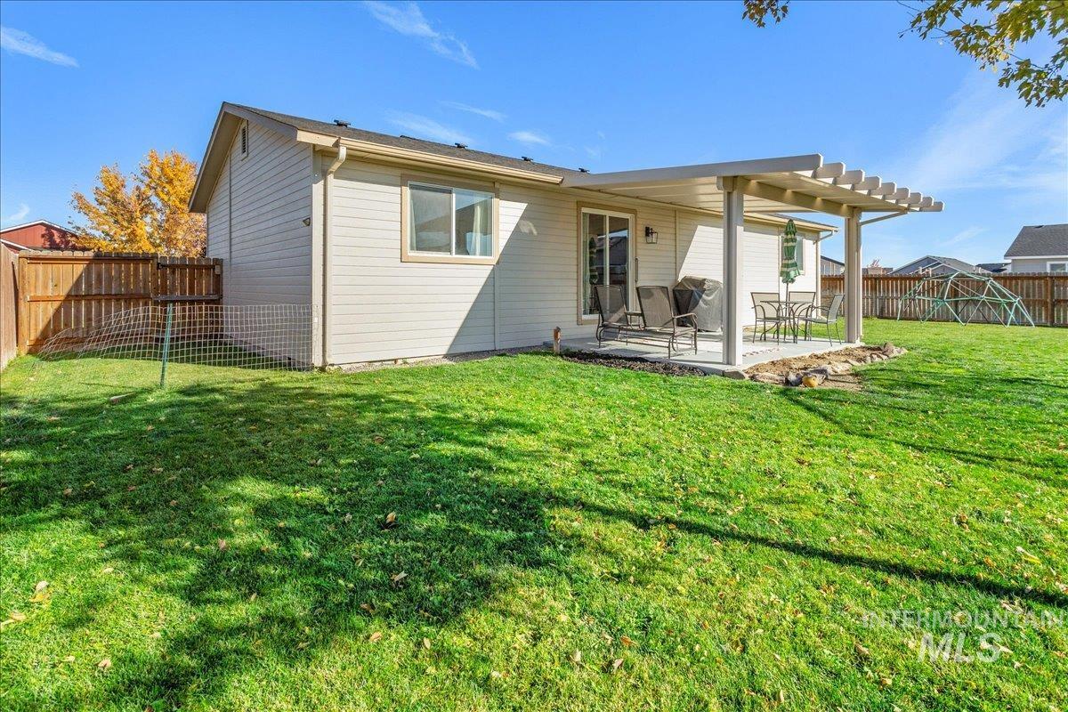 Back of house featuring a fenced backyard and a patio area