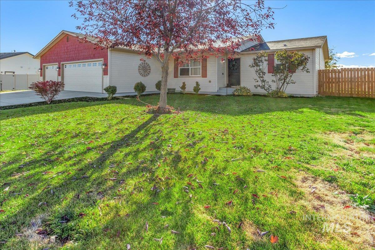 Ranch-style house featuring concrete driveway and a garage