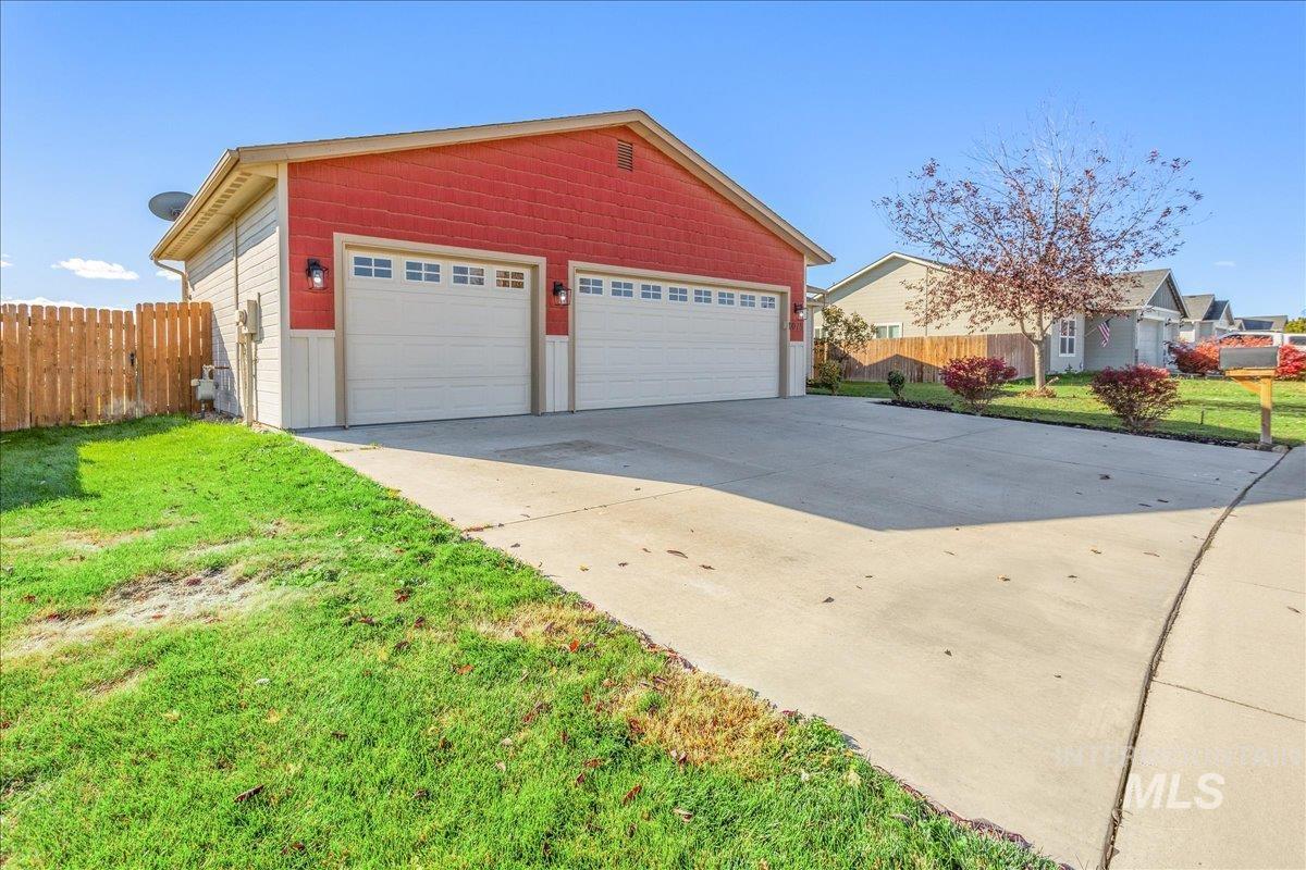 View of property exterior with a garage and an outdoor structure
