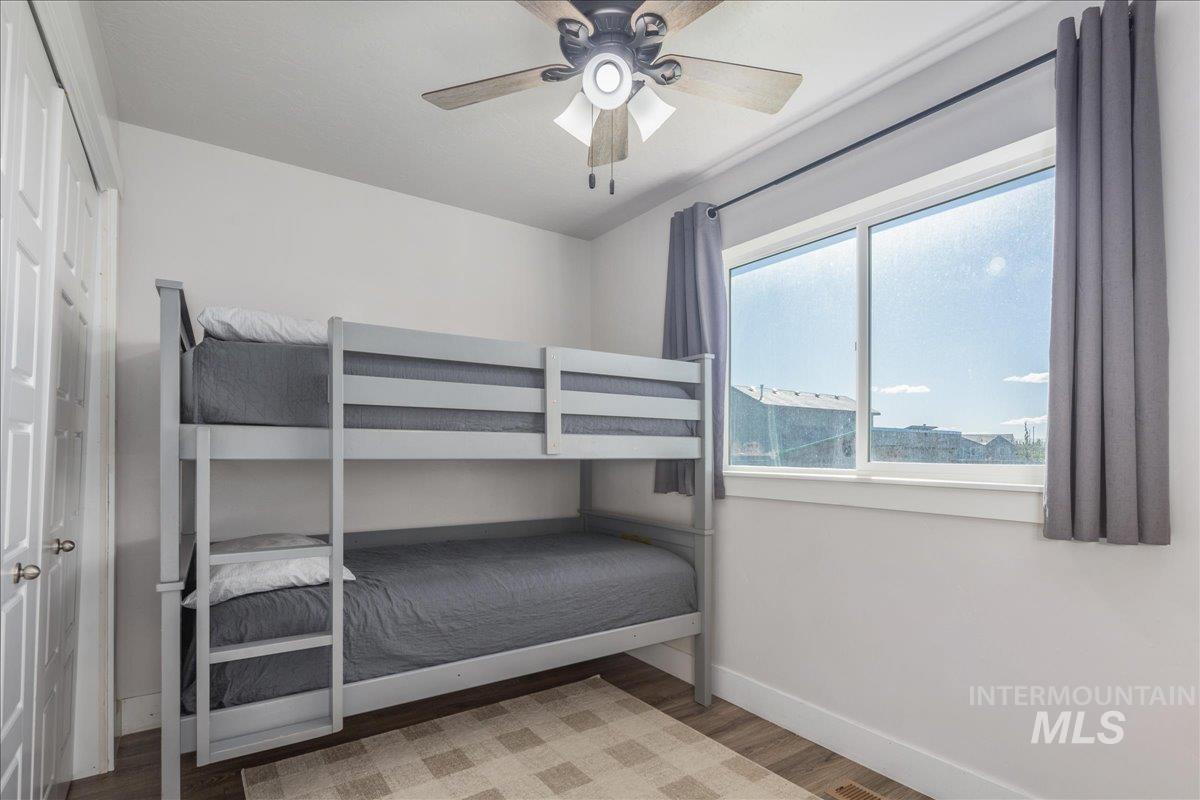 Bedroom with light wood-style flooring and ceiling fan