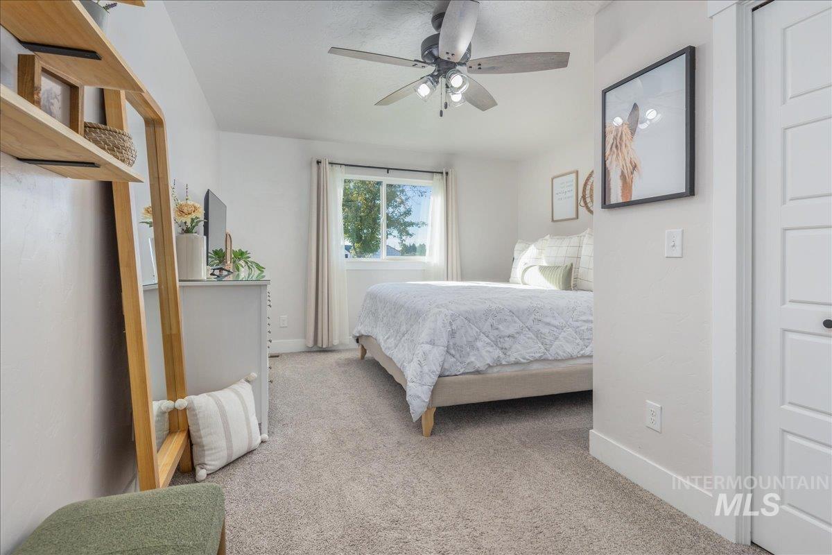 Bedroom with carpet flooring and a ceiling fan