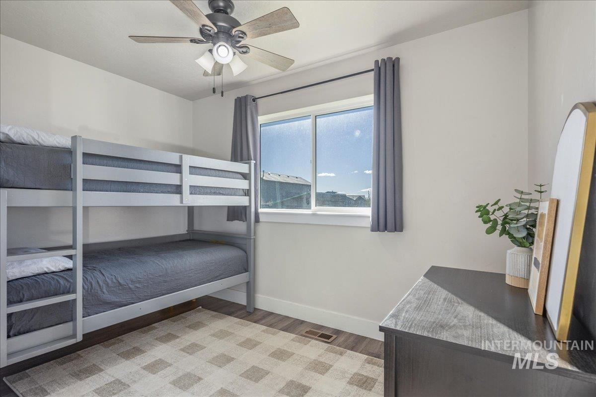 Bedroom with light wood-style flooring and ceiling fan