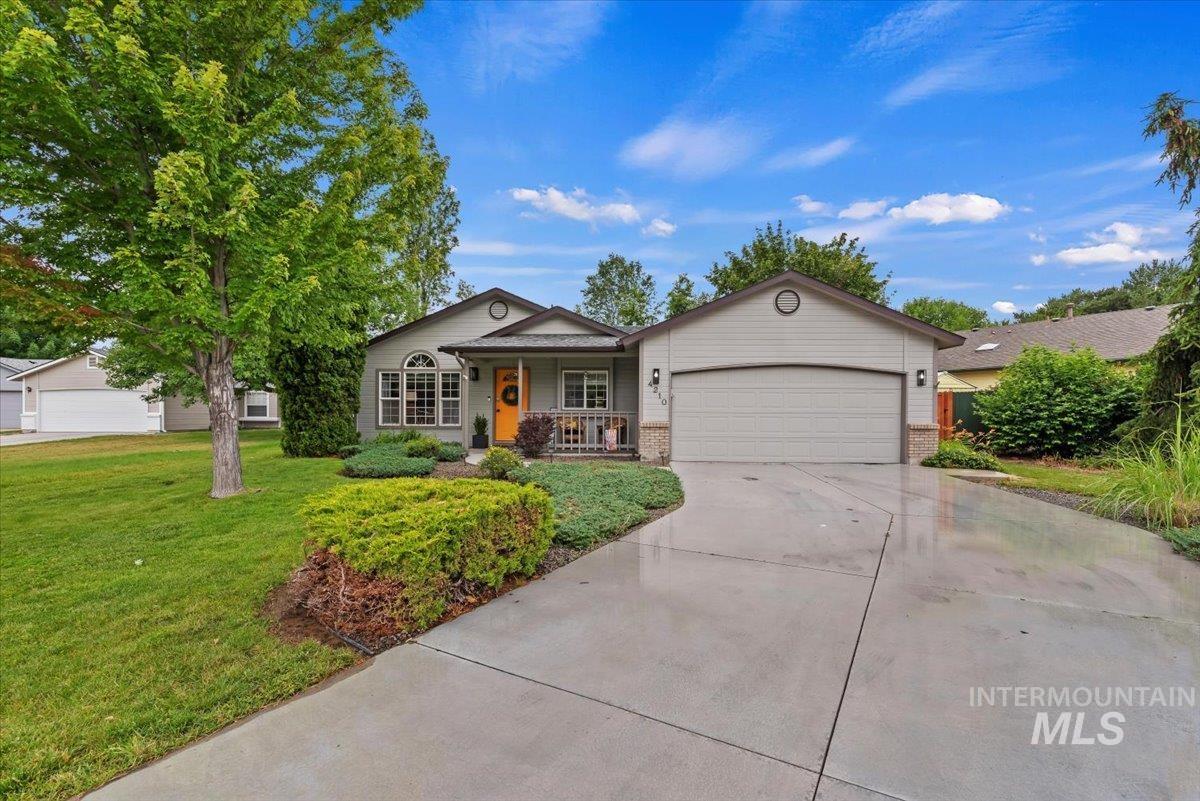 Single-story residence featuring a two-car garage, concrete driveway, and a covered front porch