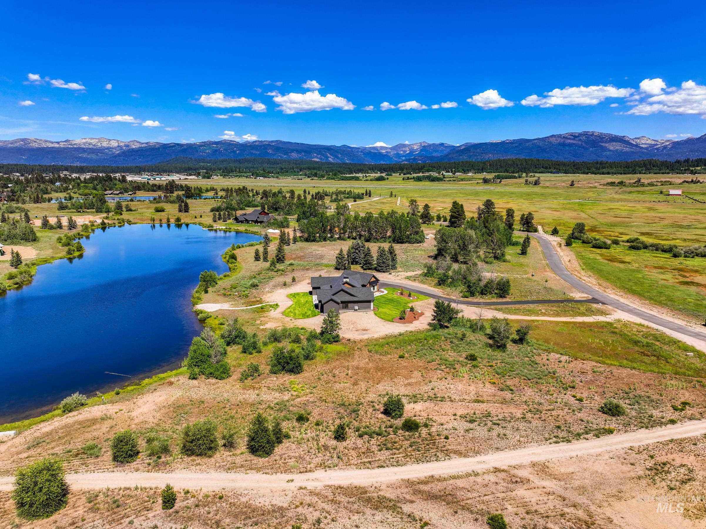 Aerial view of sparsely populated area featuring a water and mountain view