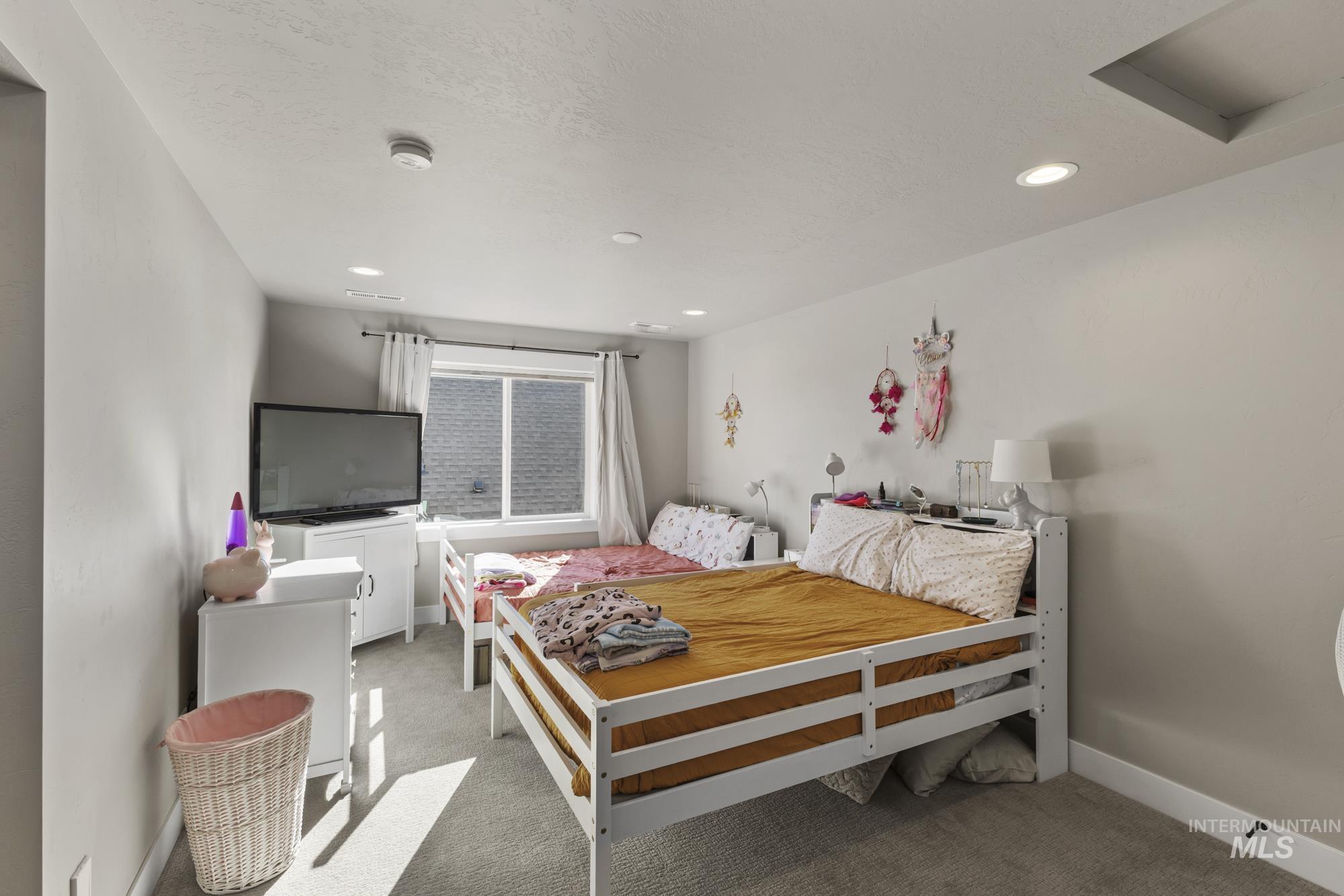 Carpeted bedroom featuring baseboards and recessed lighting