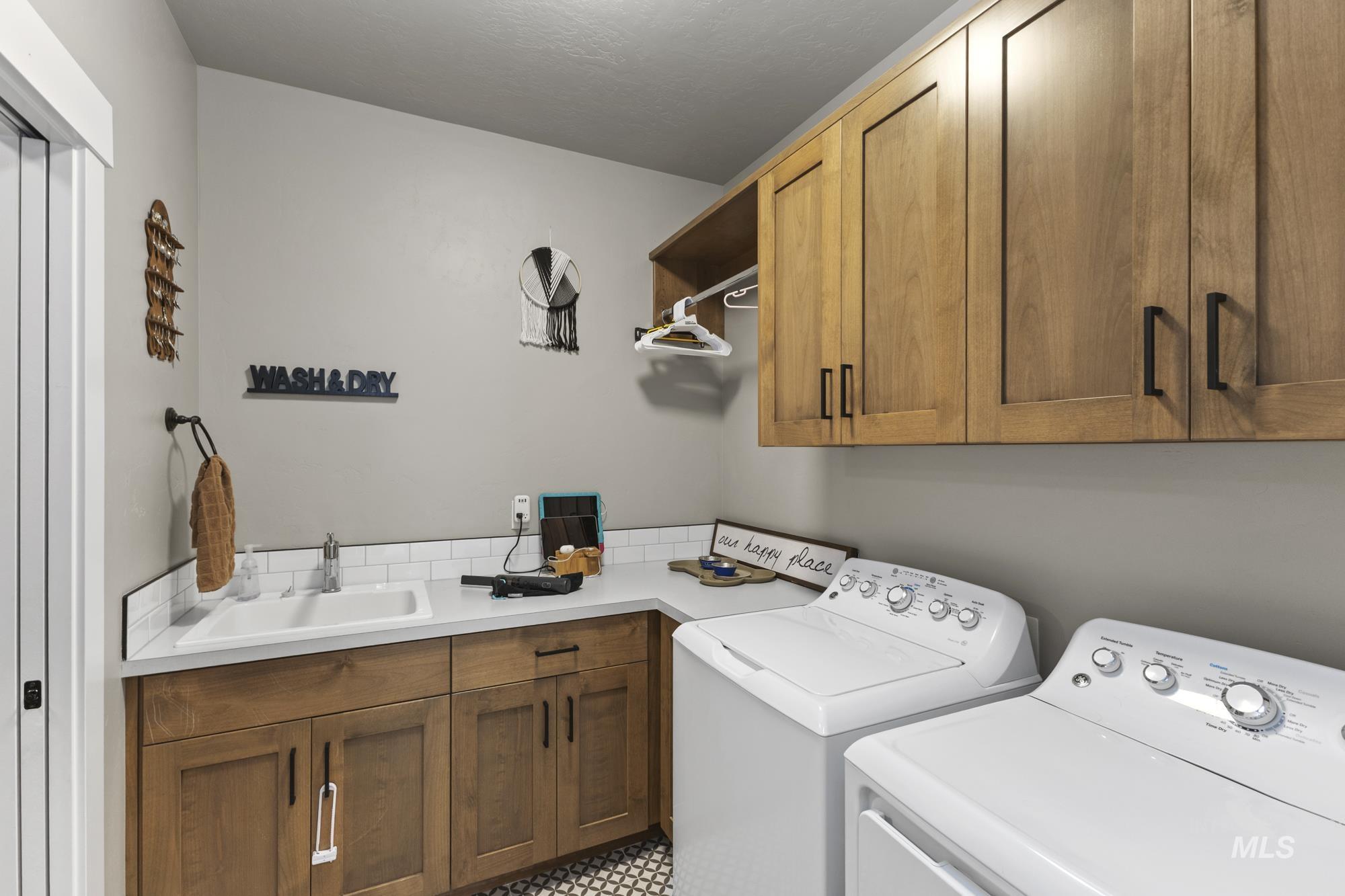 Laundry area with washing machine and dryer and cabinet space
