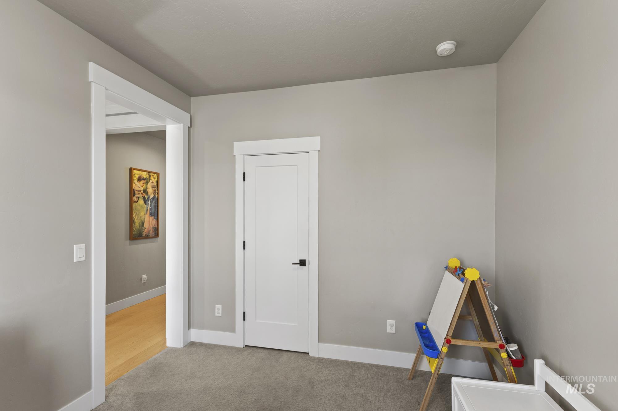 Recreation room with carpet floors and baseboards