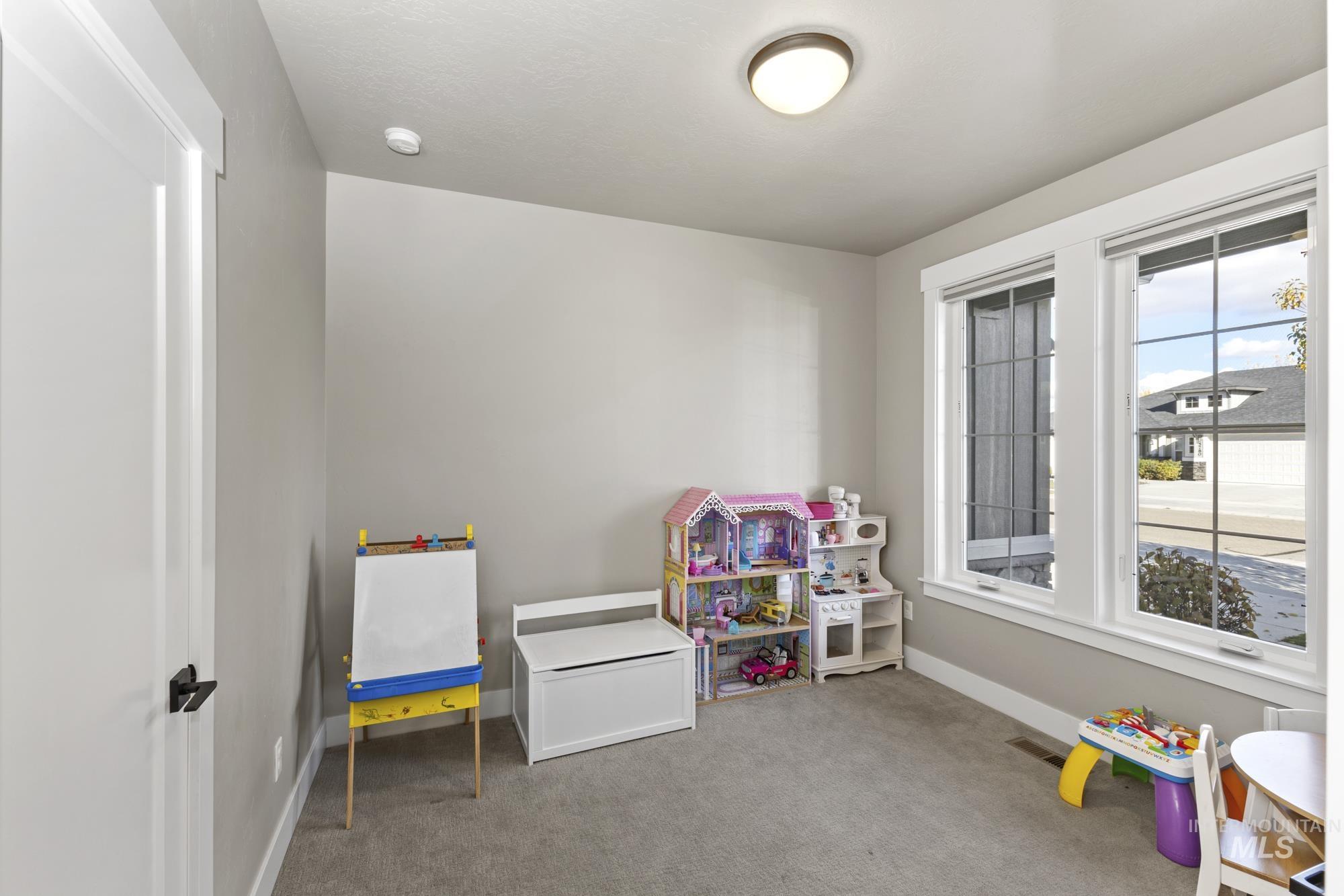 Playroom with light carpet and baseboards