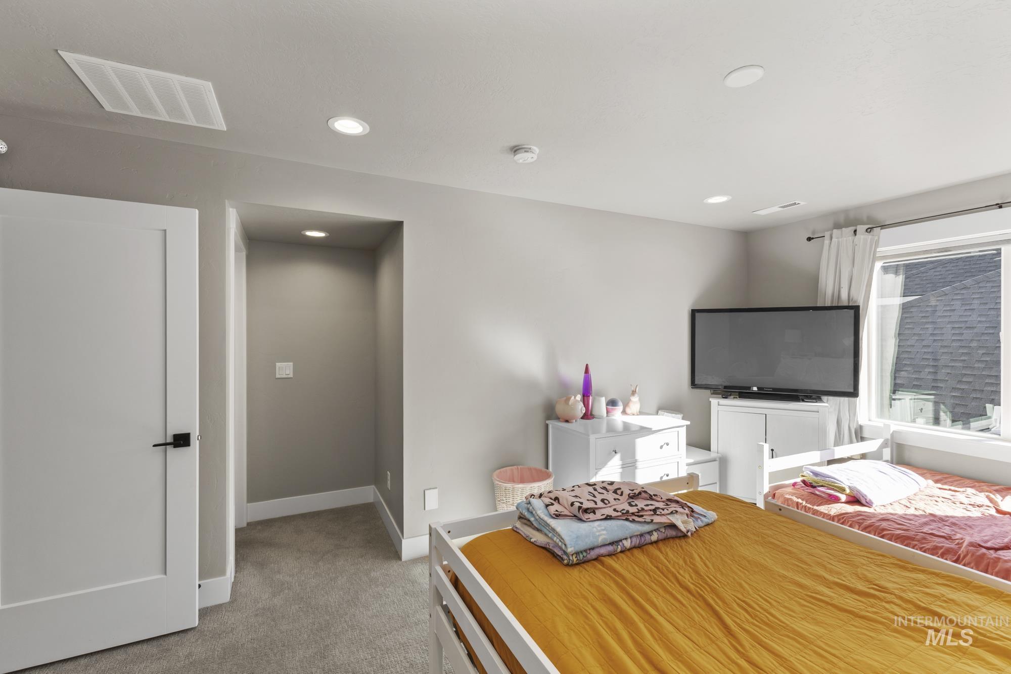 Bedroom featuring light carpet and recessed lighting