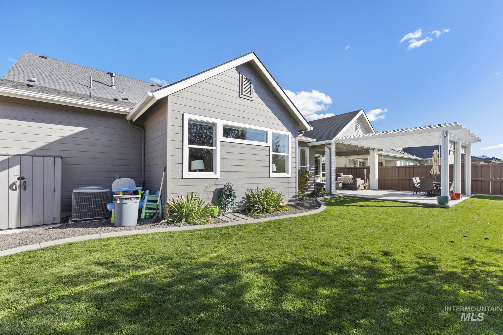 Rear view of house featuring a patio and a pergola