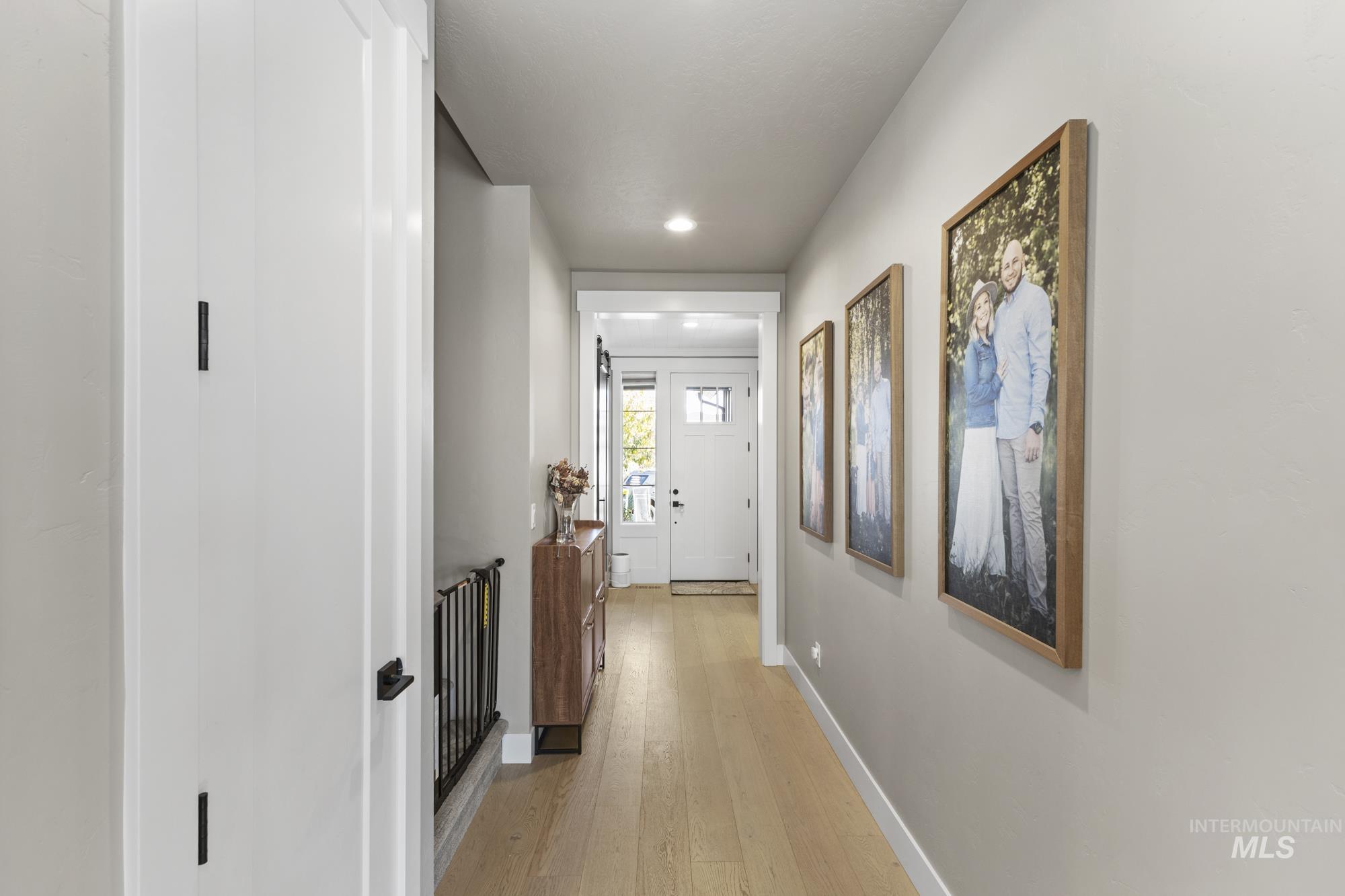 Corridor featuring light wood-style floors and recessed lighting