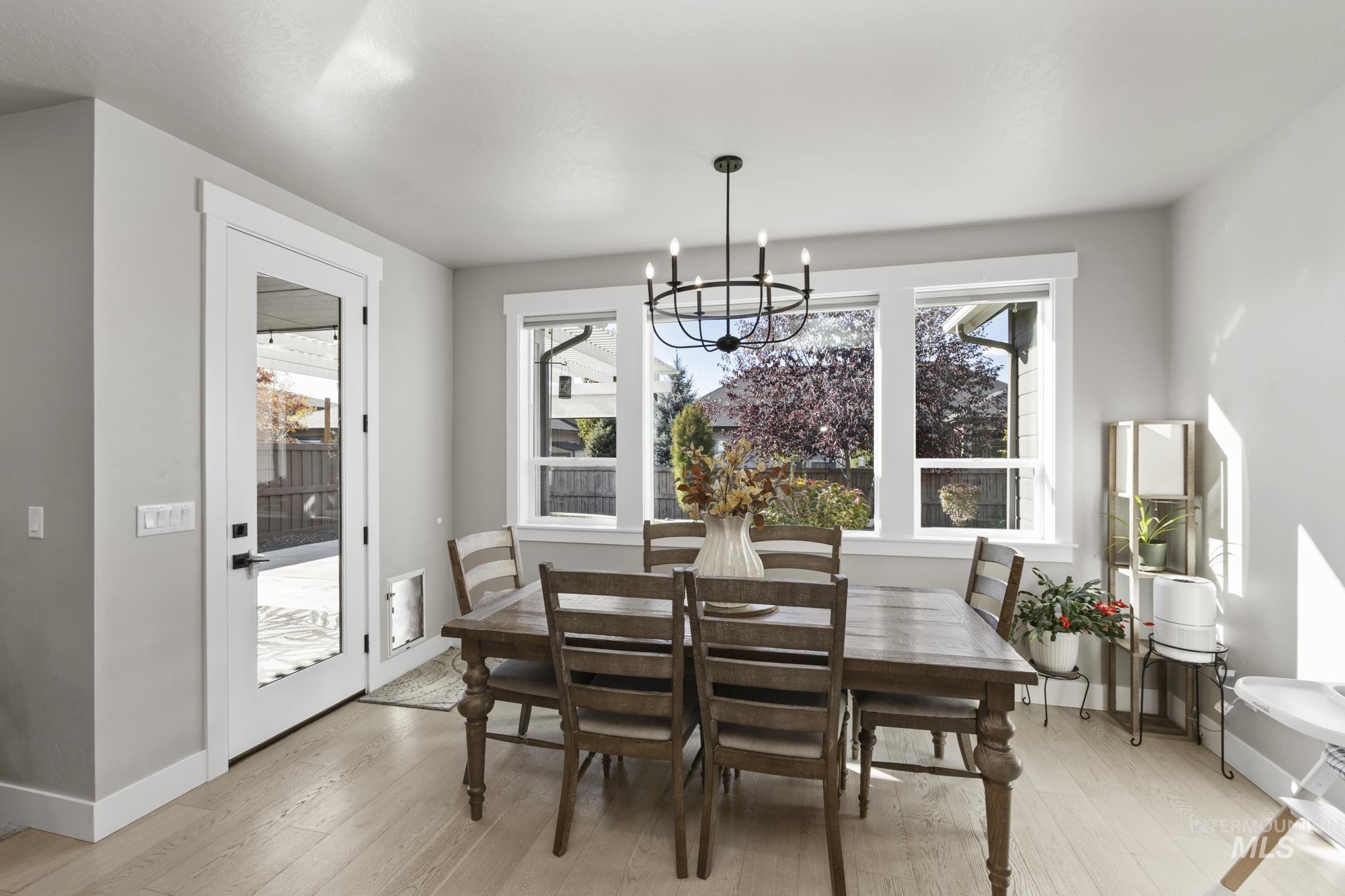 Dining room featuring light wood-style floors and a chandelier