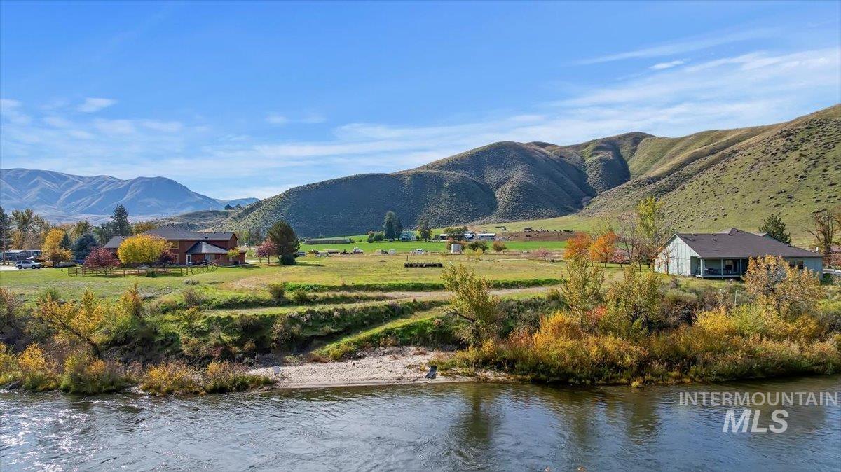 View of mountain background with a nearby body of water and rural landscape