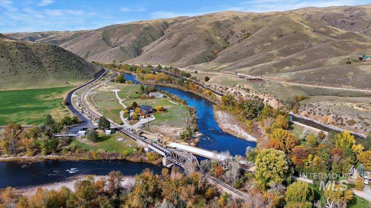 Aerial view of property's location featuring a water and mountain view