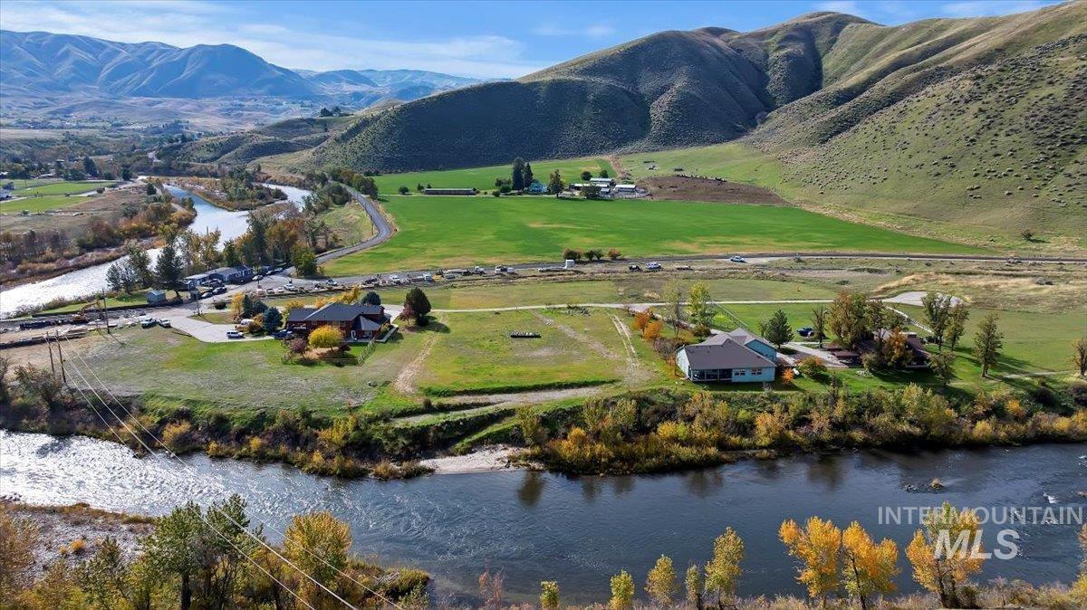 Aerial view of sparsely populated area with a water and mountain view
