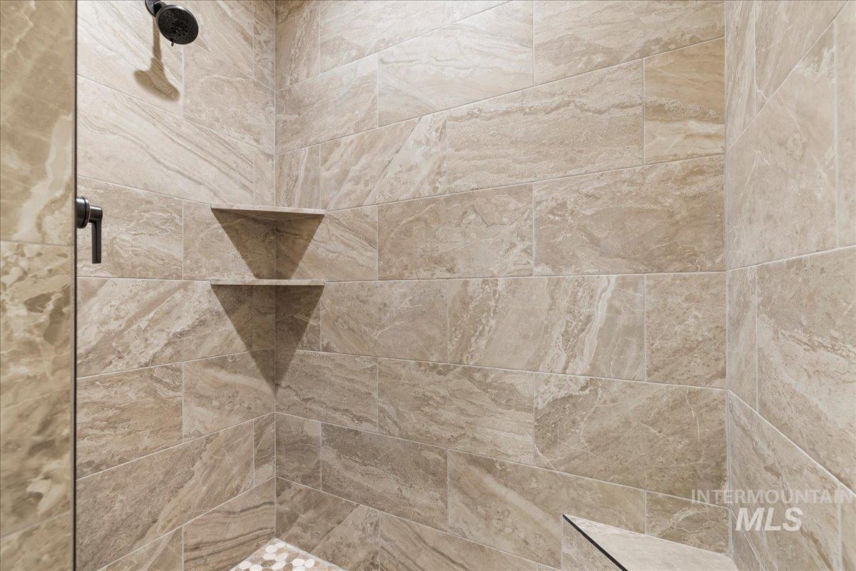 Bathroom view of a tile shower