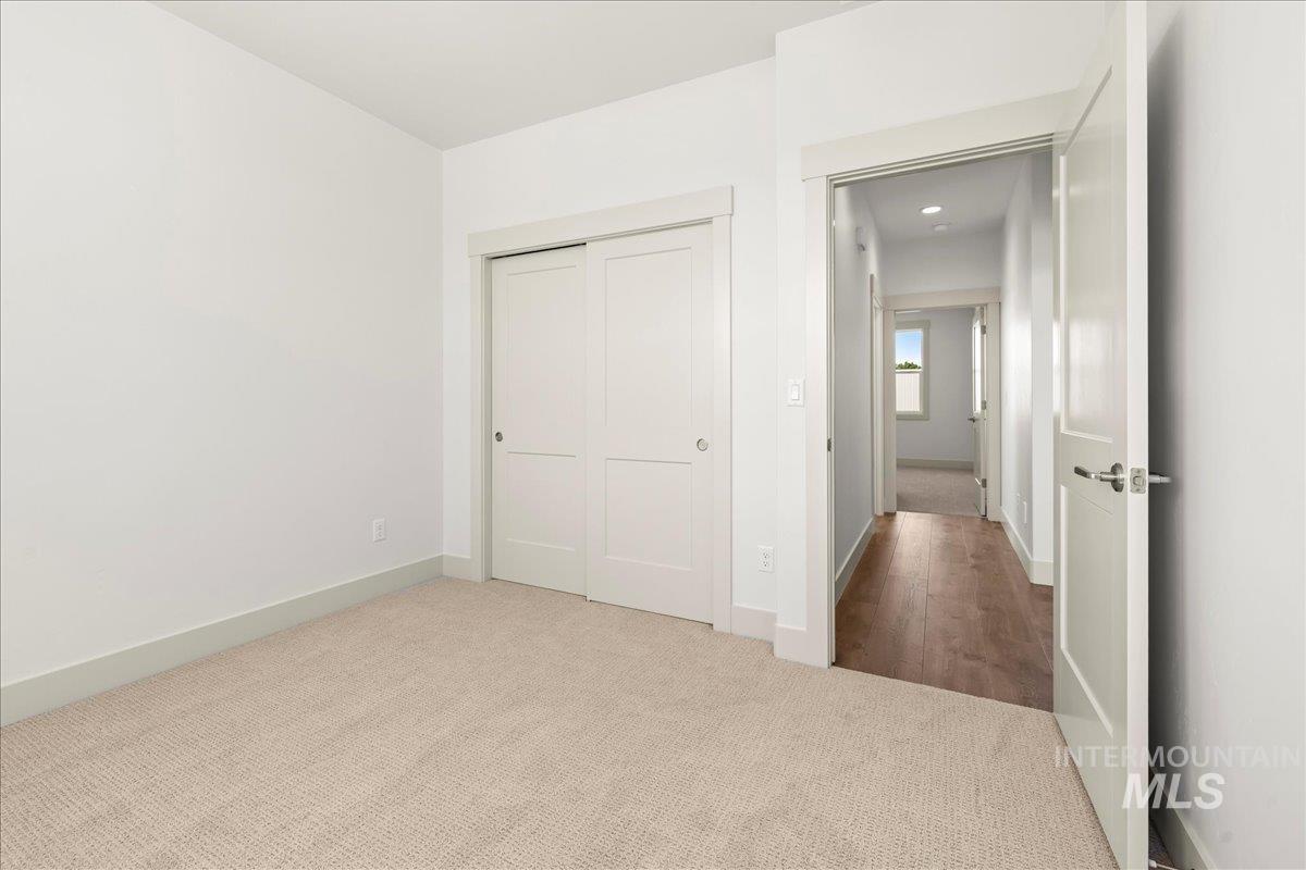 Unfurnished bedroom with carpet floors and a closet