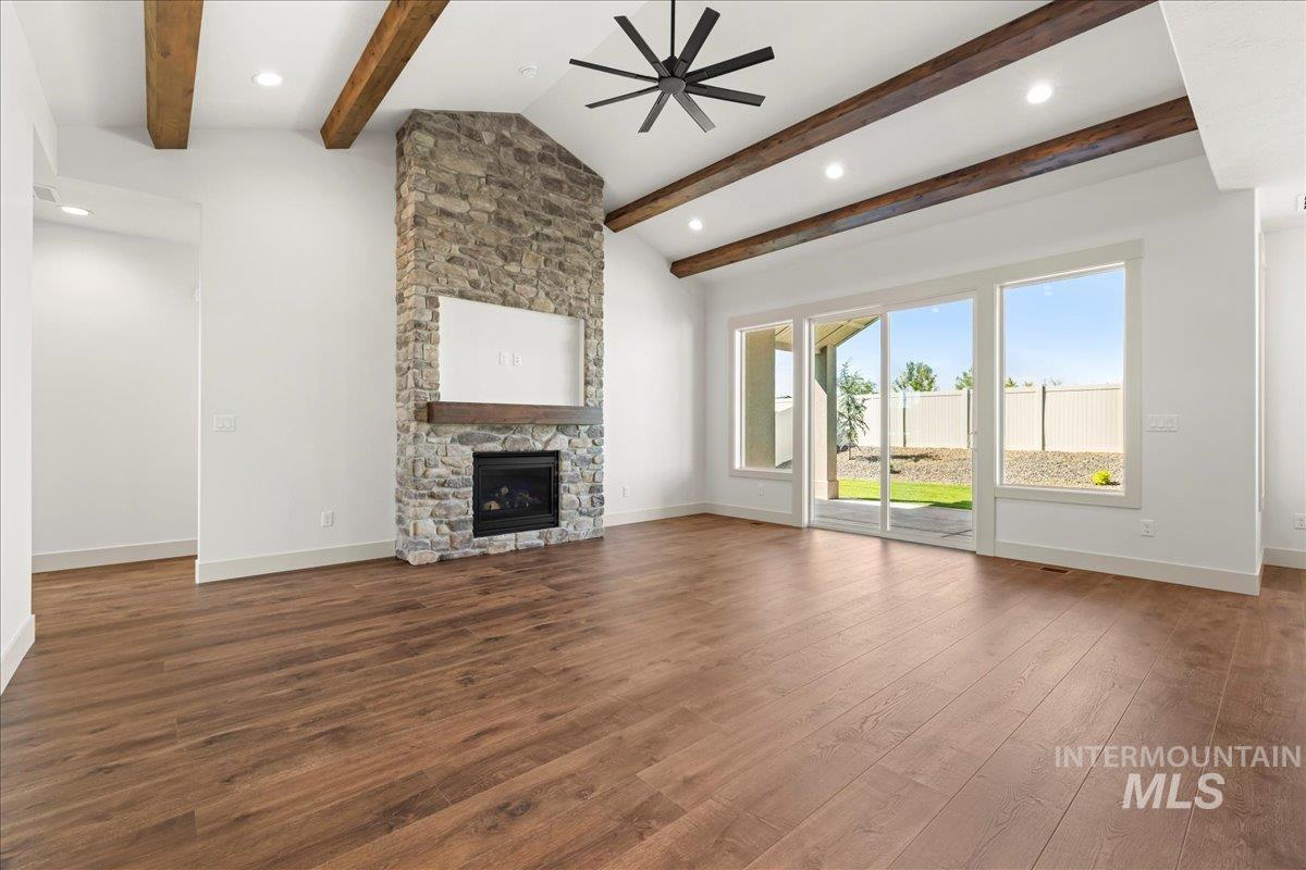 Unfurnished living room featuring wood finished floors, a ceiling fan, a fireplace, and recessed lighting