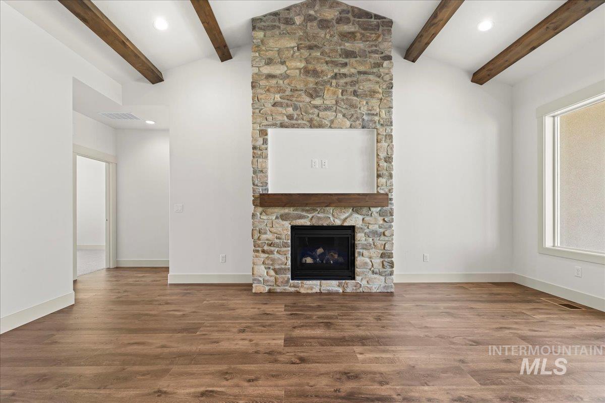 Unfurnished living room with wood finished floors, recessed lighting, and a fireplace
