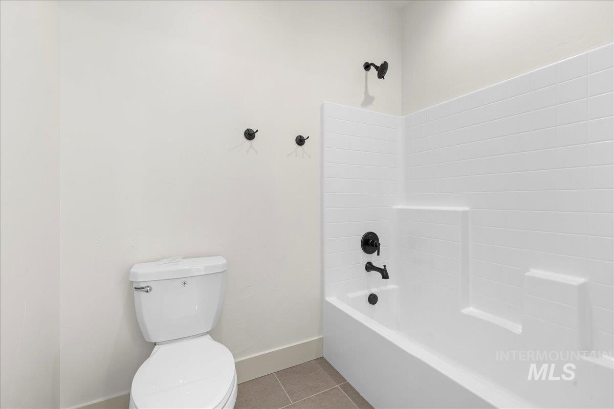 Full bathroom with tile patterned floors and  shower combination