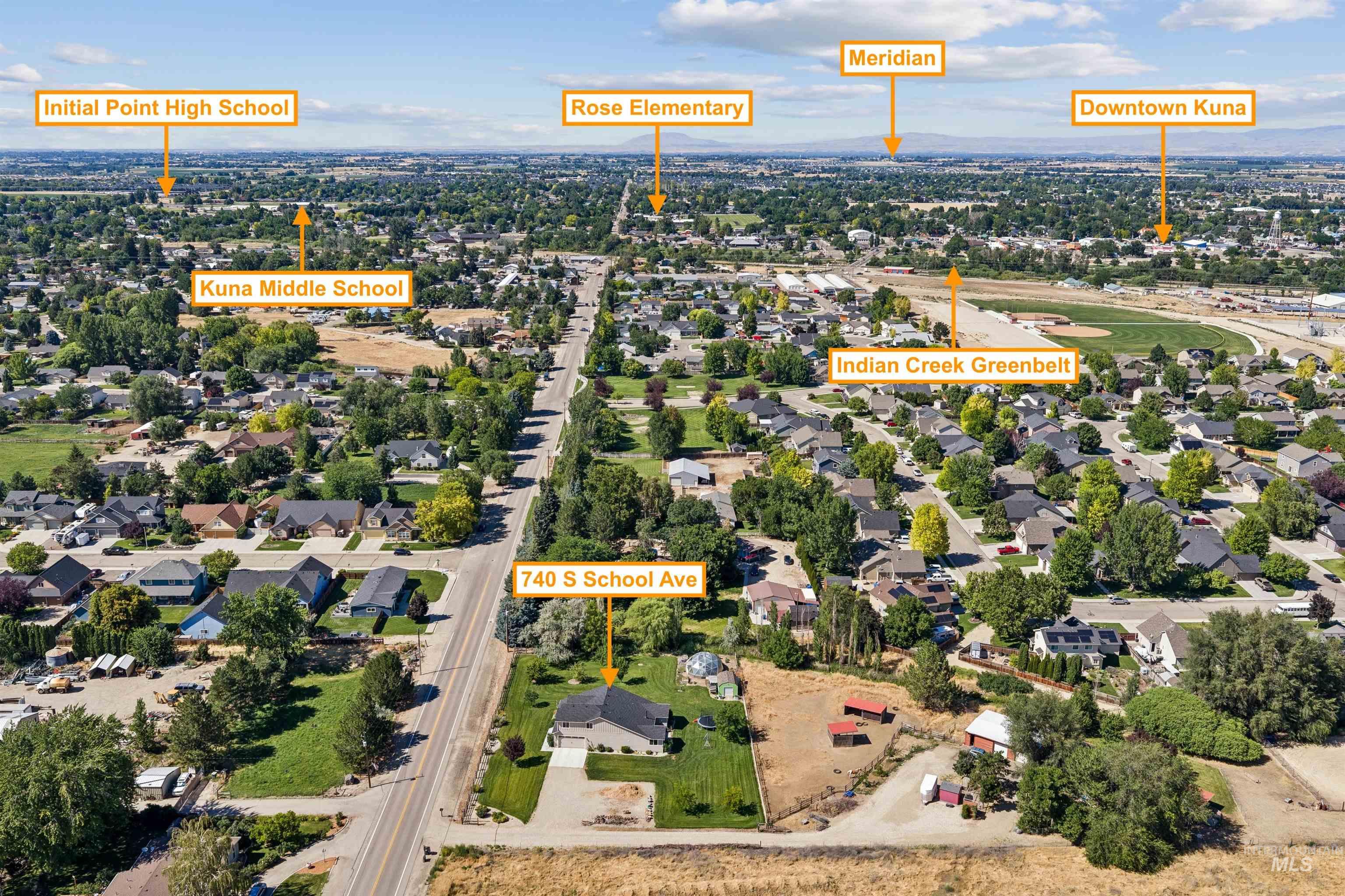 Aerial view showcasing a residential property with ample surrounding land