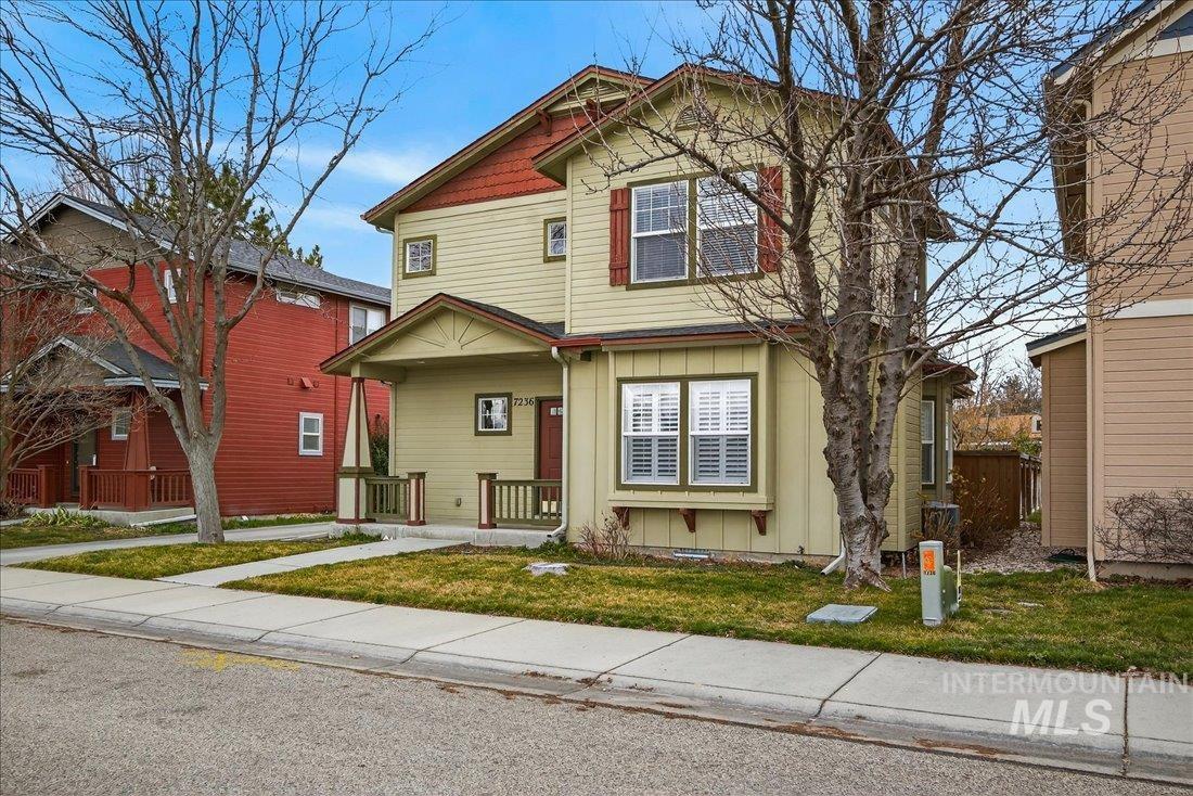 Craftsman inspired home featuring board and batten siding, a porch, and a front yard