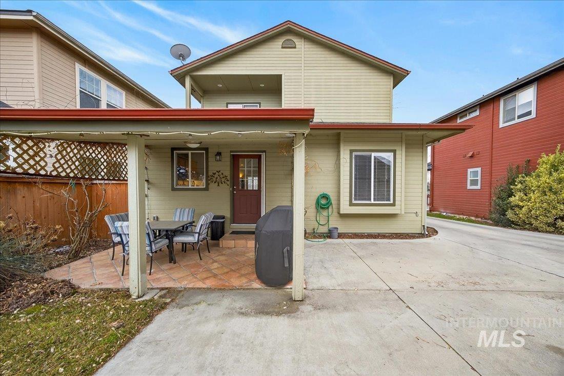 Back of property with a patio and outdoor dining area