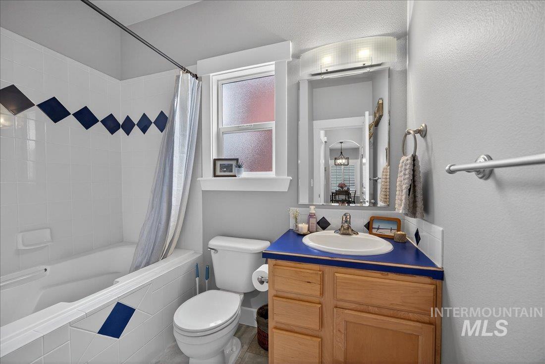 Downstairs full bath featuring vanity and tiled shower / bath combo