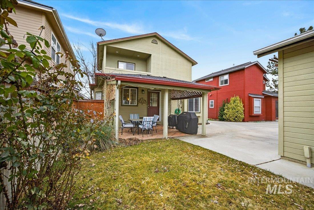 Back of property with a patio area and a lawn