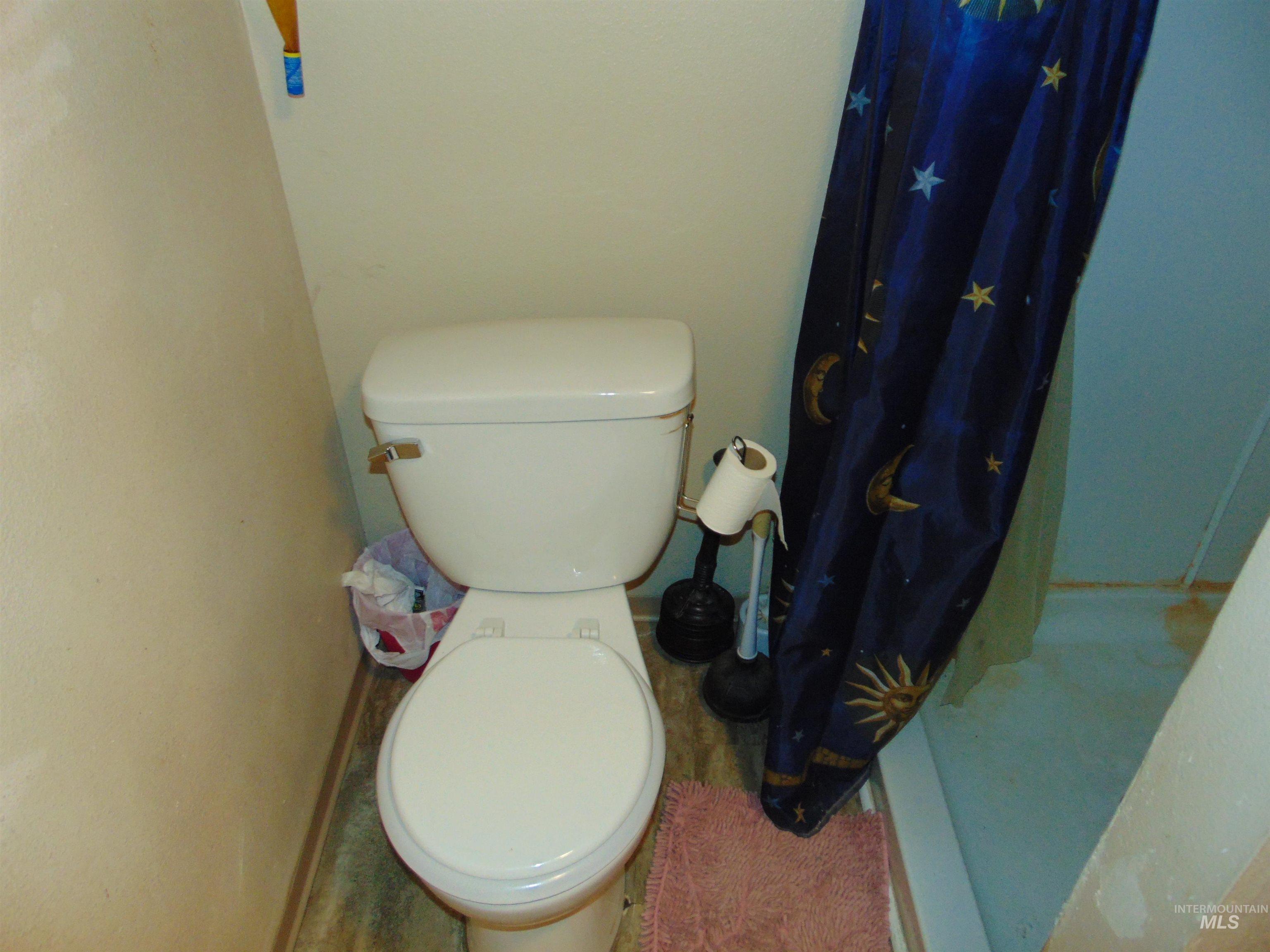 Full bath featuring a stall shower and toilet