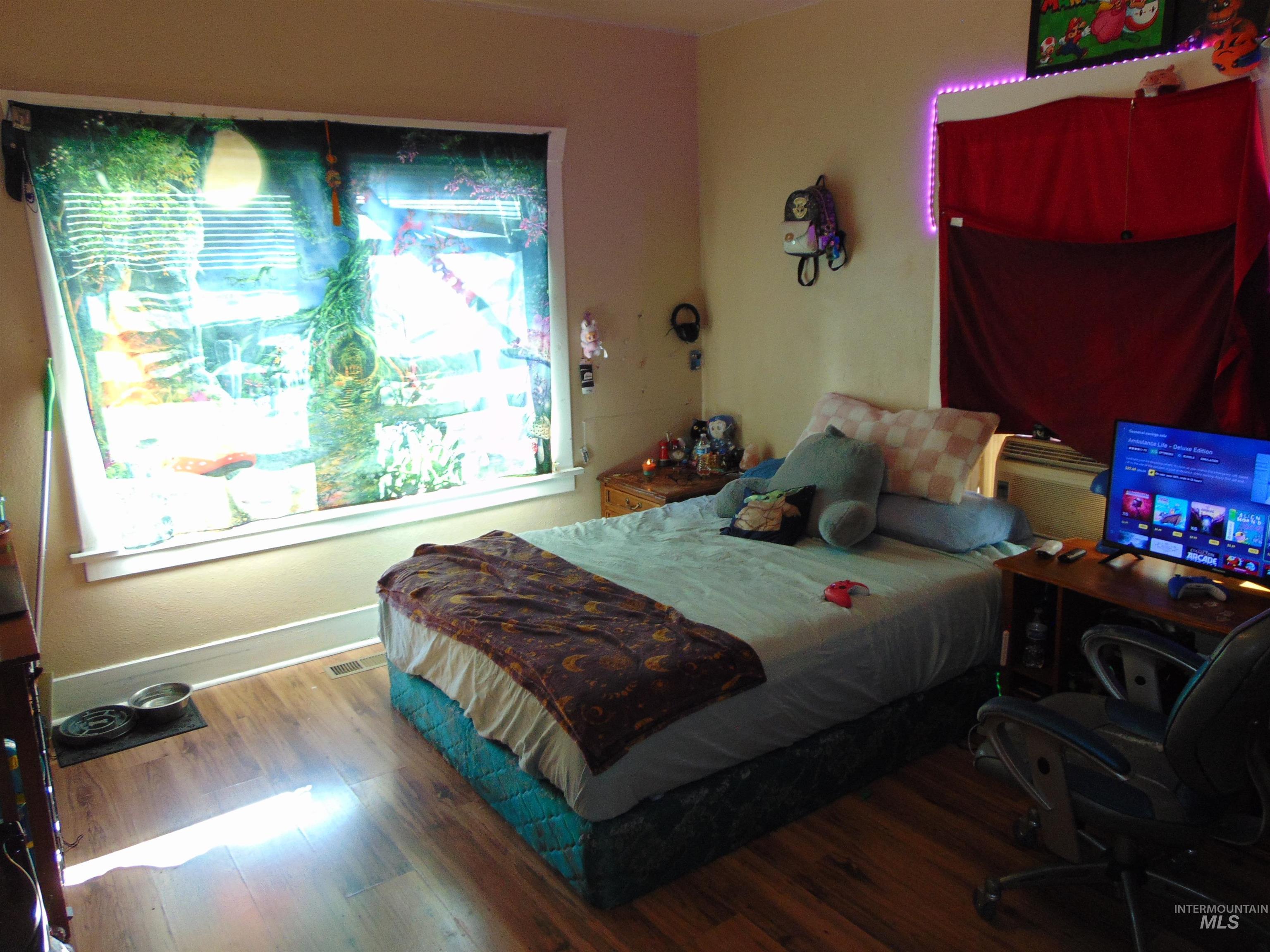 Bedroom featuring wood finished floors and baseboards