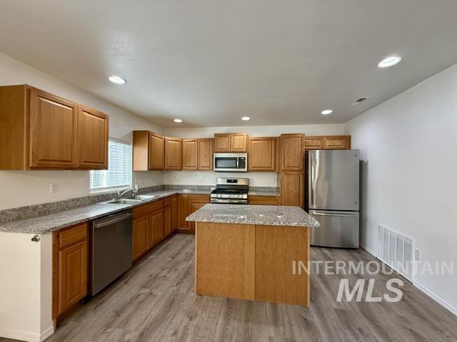 Kitchen featuring wood-finish cabinetry and a central island