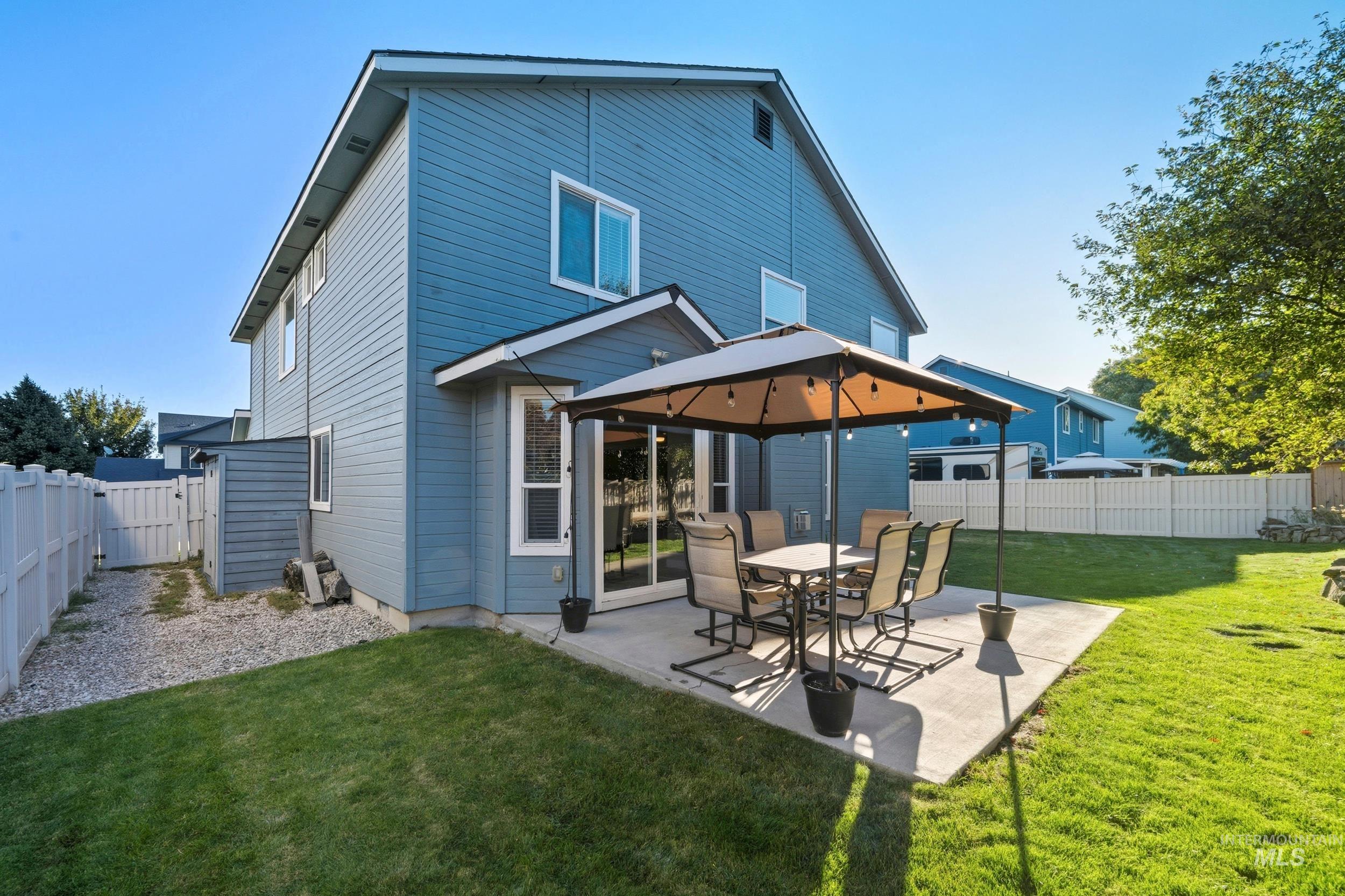 Back of house featuring a fenced backyard, a patio area, and a gazebo