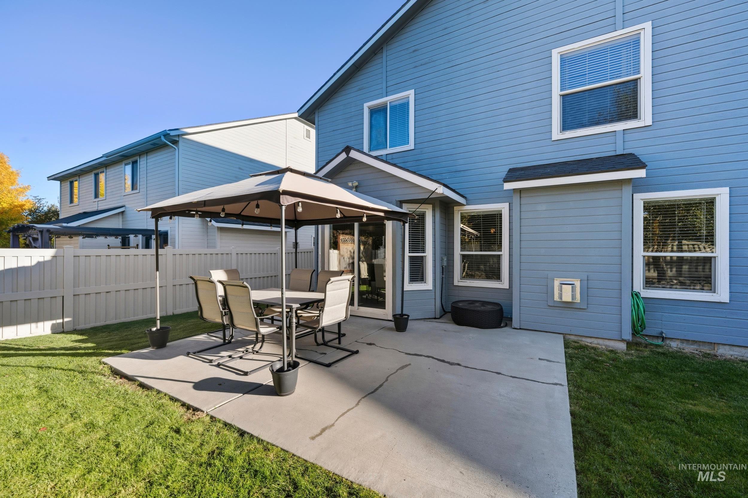 Back of property featuring a gazebo and a patio area