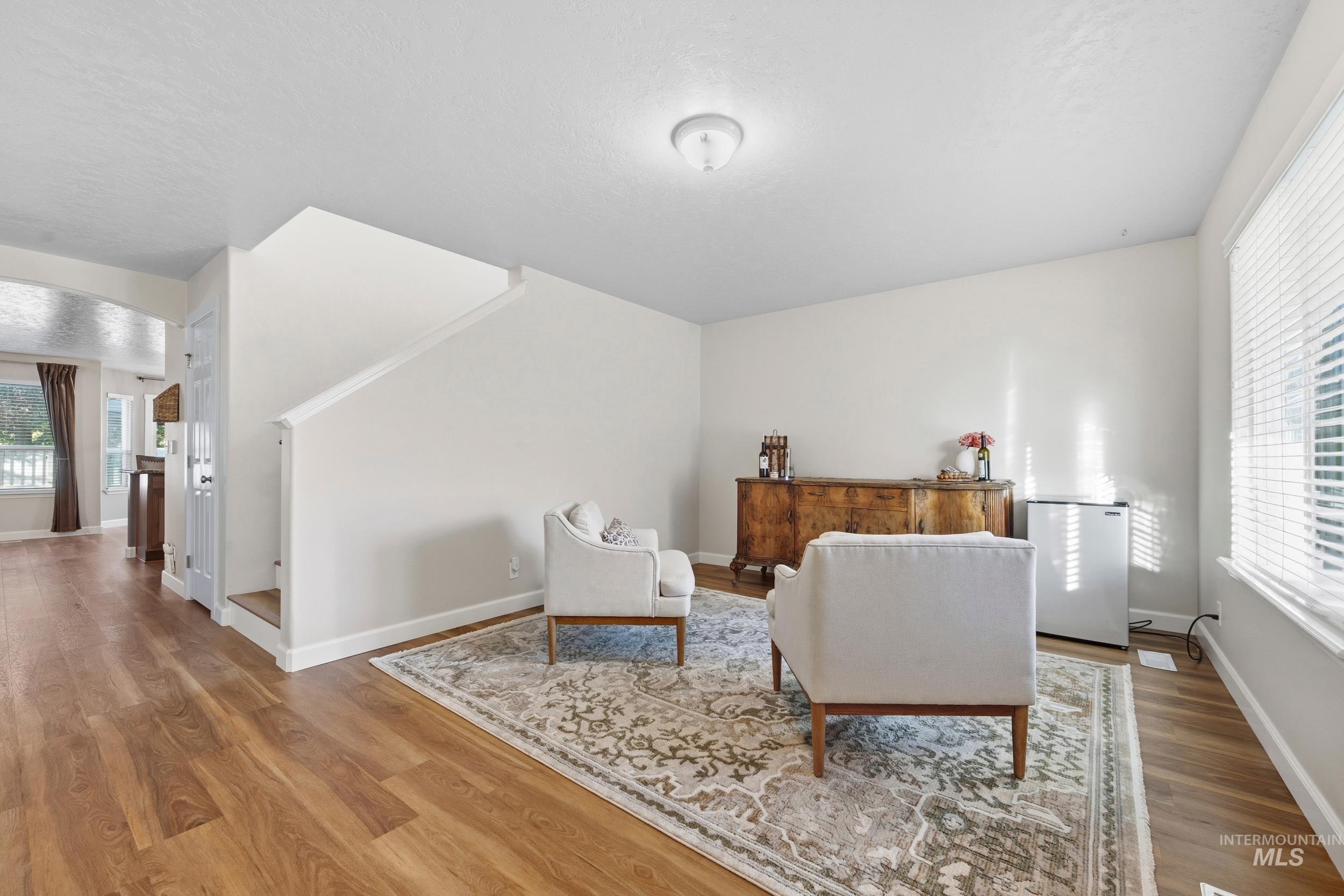 Sitting room featuring a textured ceiling and light wood-type flooring