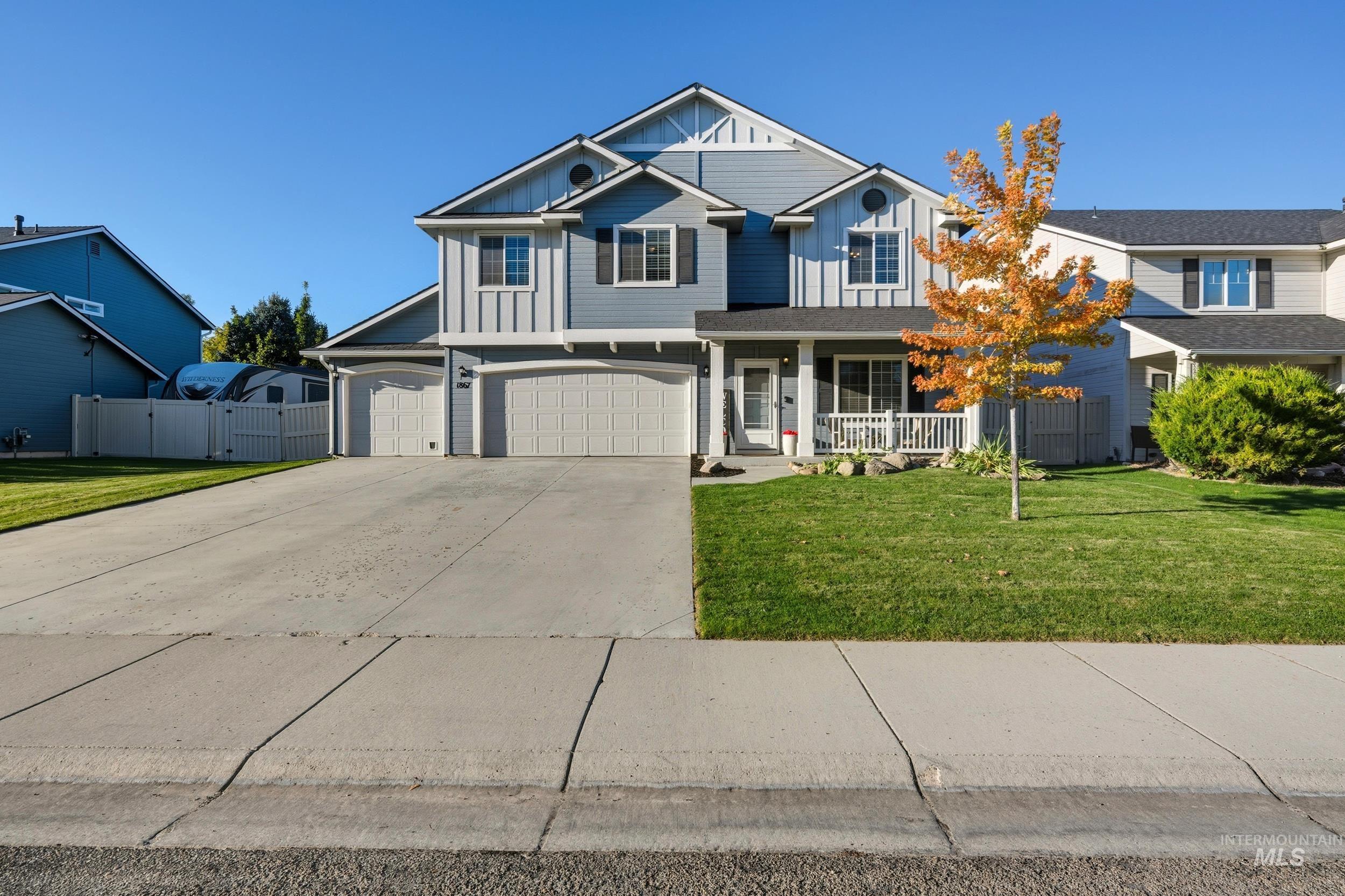 View of front facade featuring board and batten siding, concrete driveway, covered porch, and an attached garage