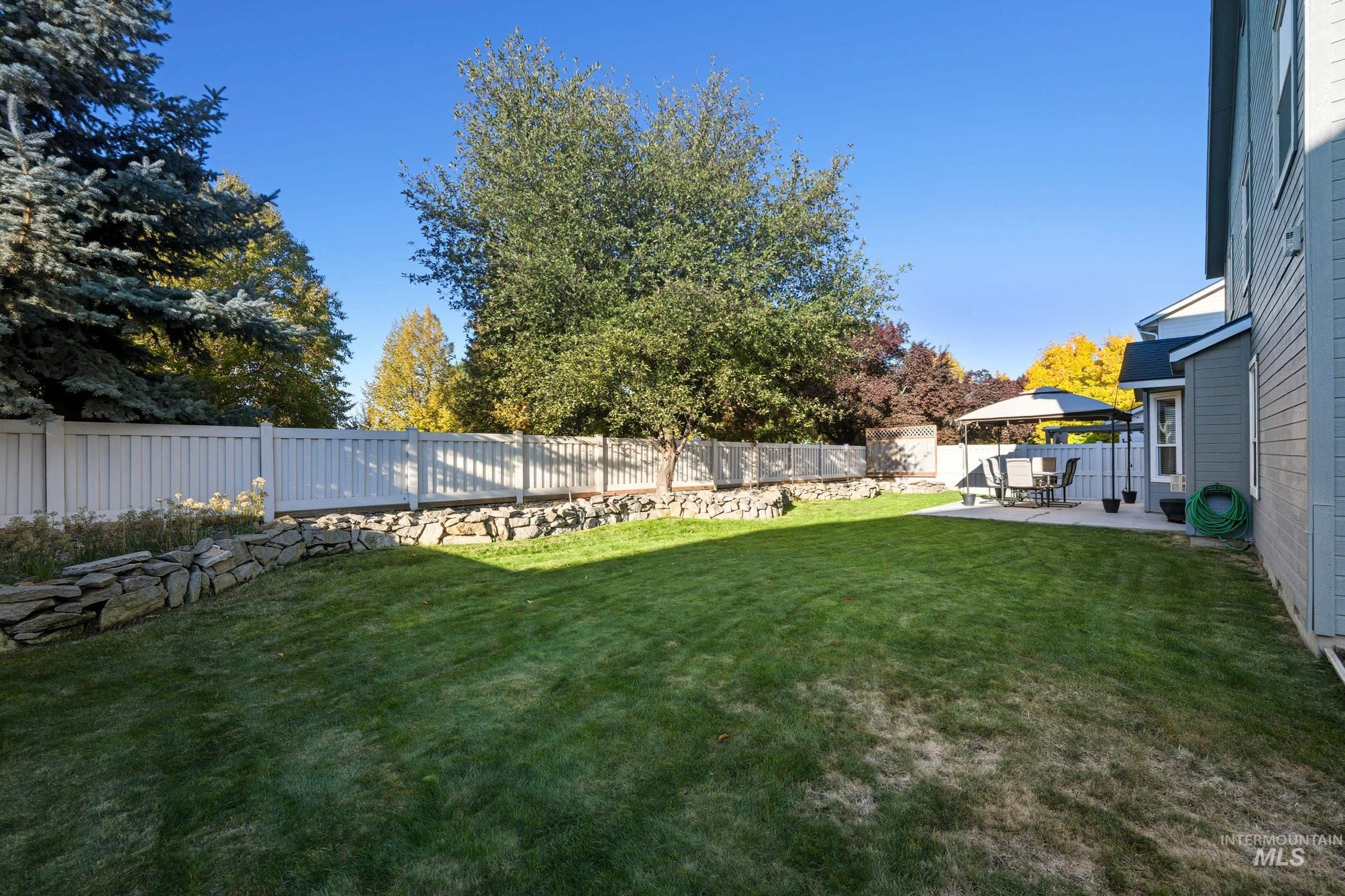 Fenced backyard with a patio area and a gazebo