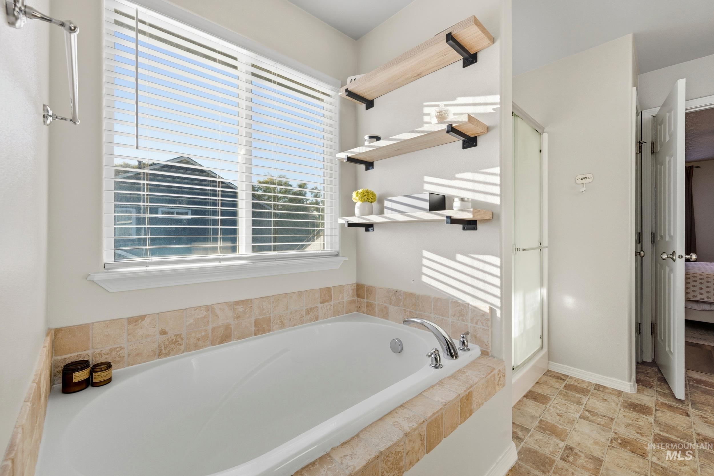 Ensuite bathroom with a bath and a shower stall