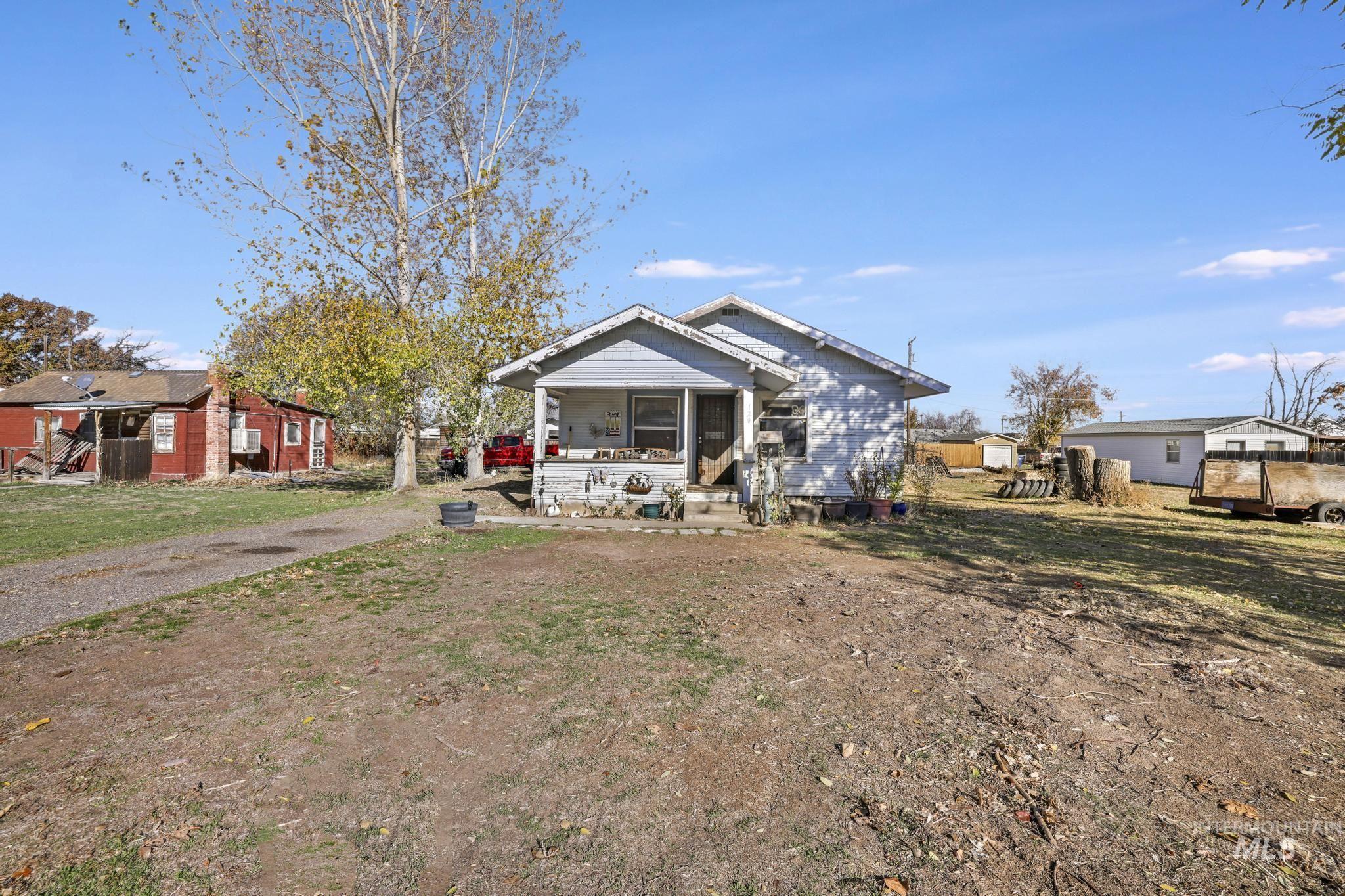 Bungalow-style house with a front lawn and a sunroom
