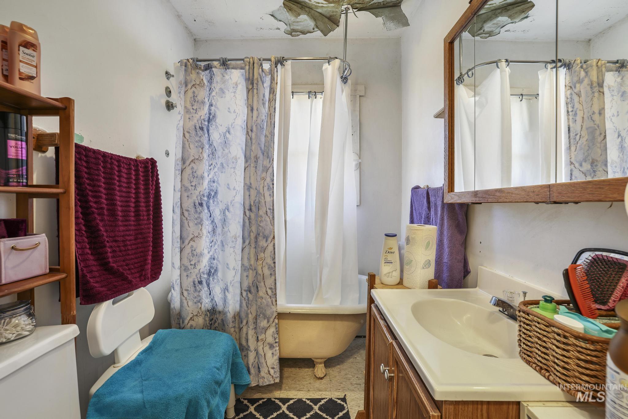 Full bathroom featuring vanity and shower / tub combo with curtain