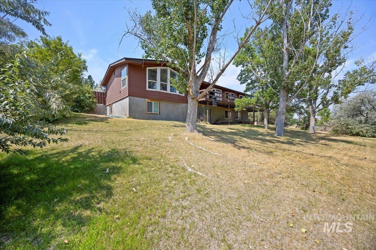 Rear view of house featuring a yard and a deck