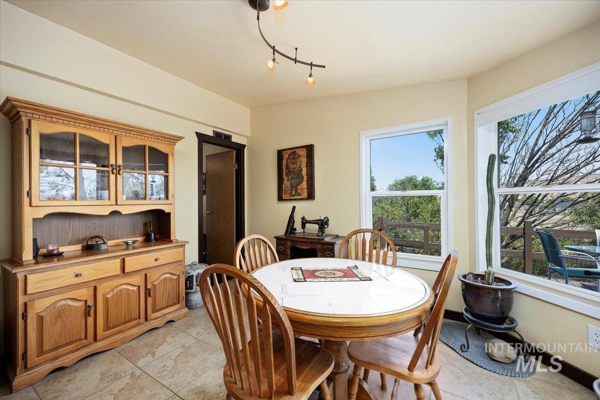 Dining space with light tile patterned floors