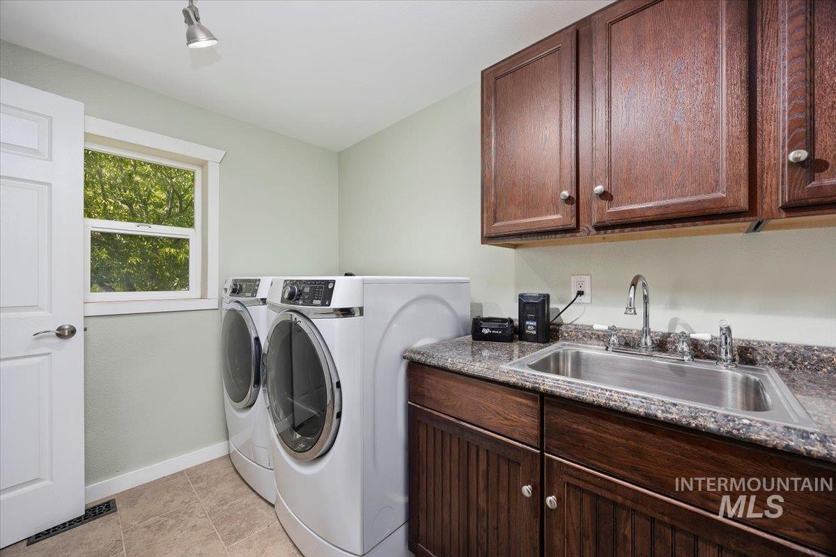 Laundry area featuring cabinet space and independent washer and dryer