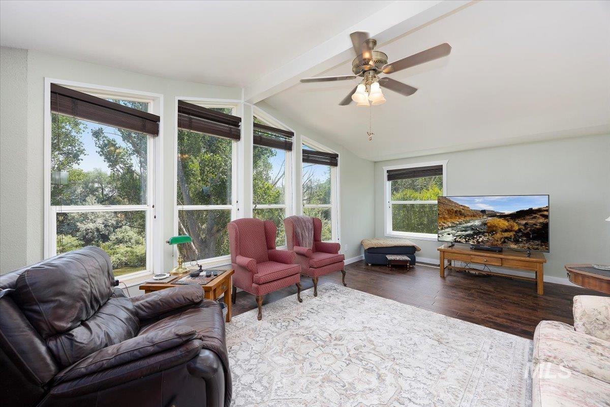Living room with wood finished floors and ceiling fan